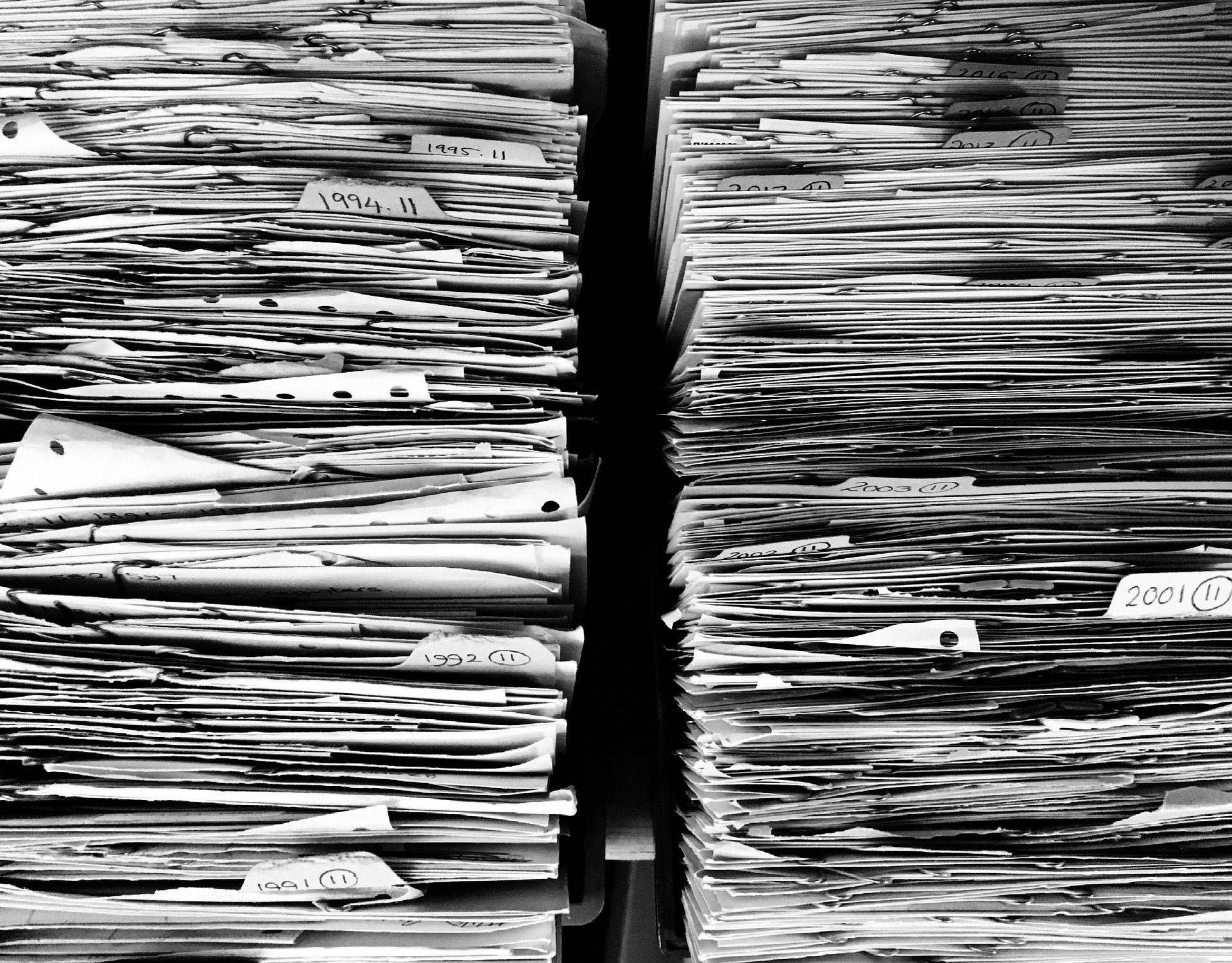 Archived paper records organized in labeled document files