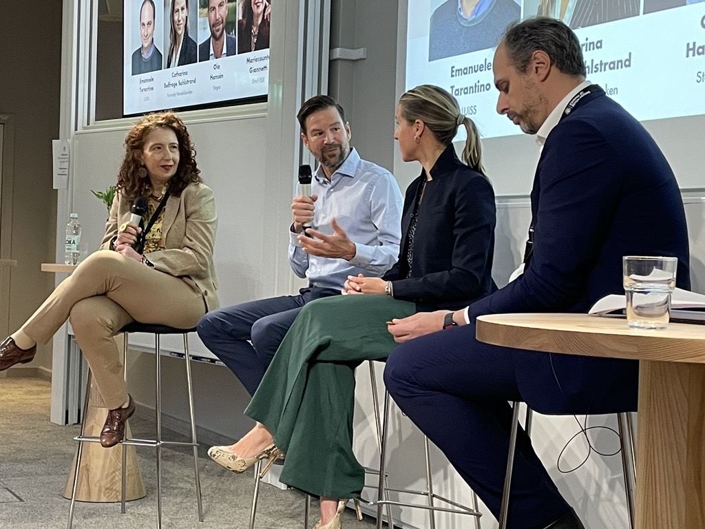 Panel discussion with four speakers at a conference event