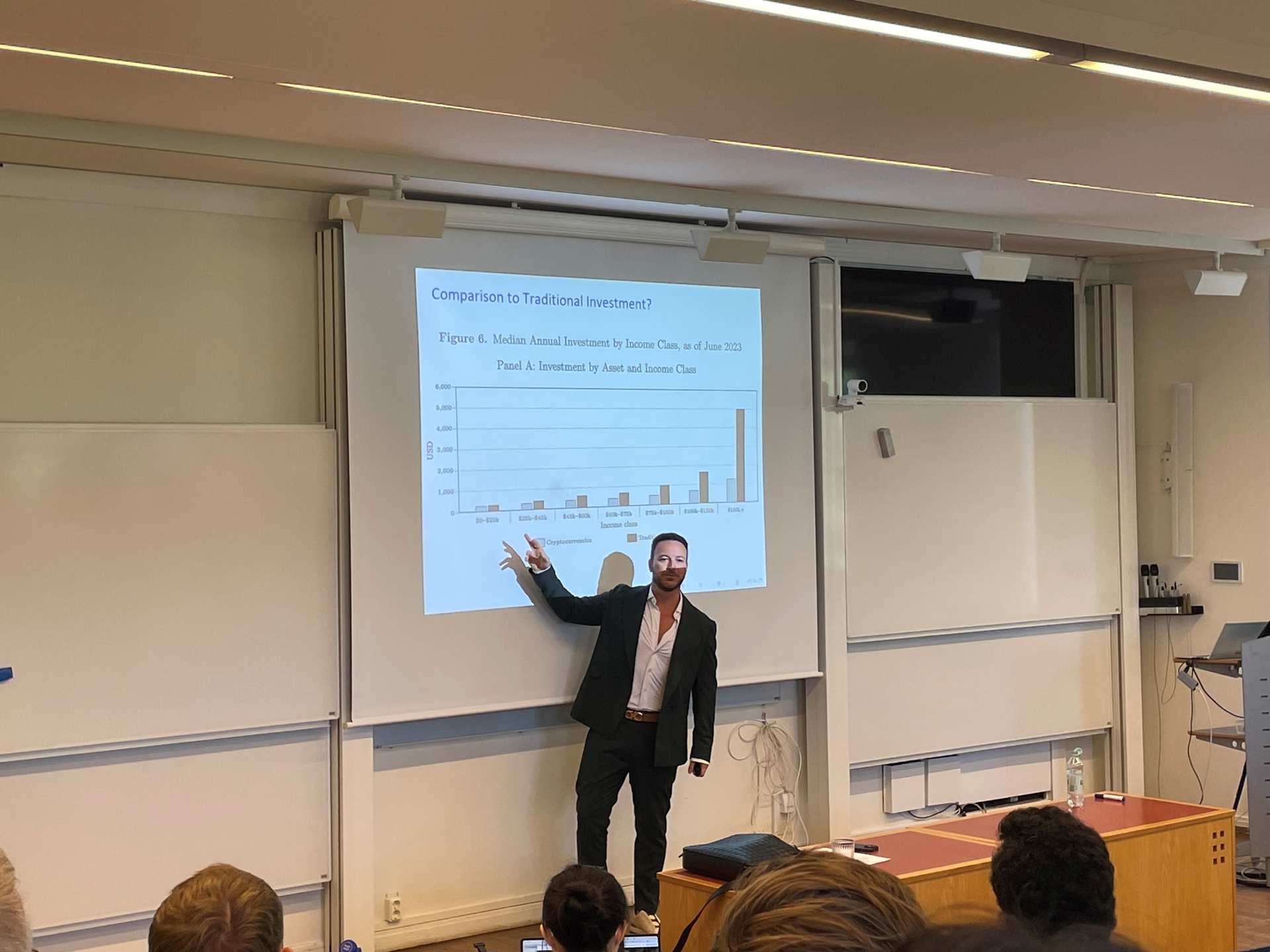  Speaker presenting a chart on cryptocurrency investment during a Swedish House of Finance seminar.