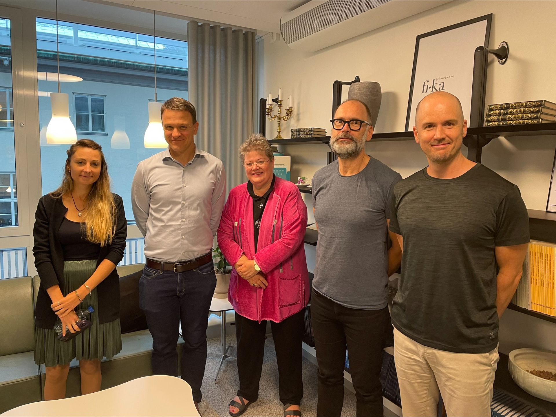  Five participants posing during a meeting at the Swedish House of Finance.