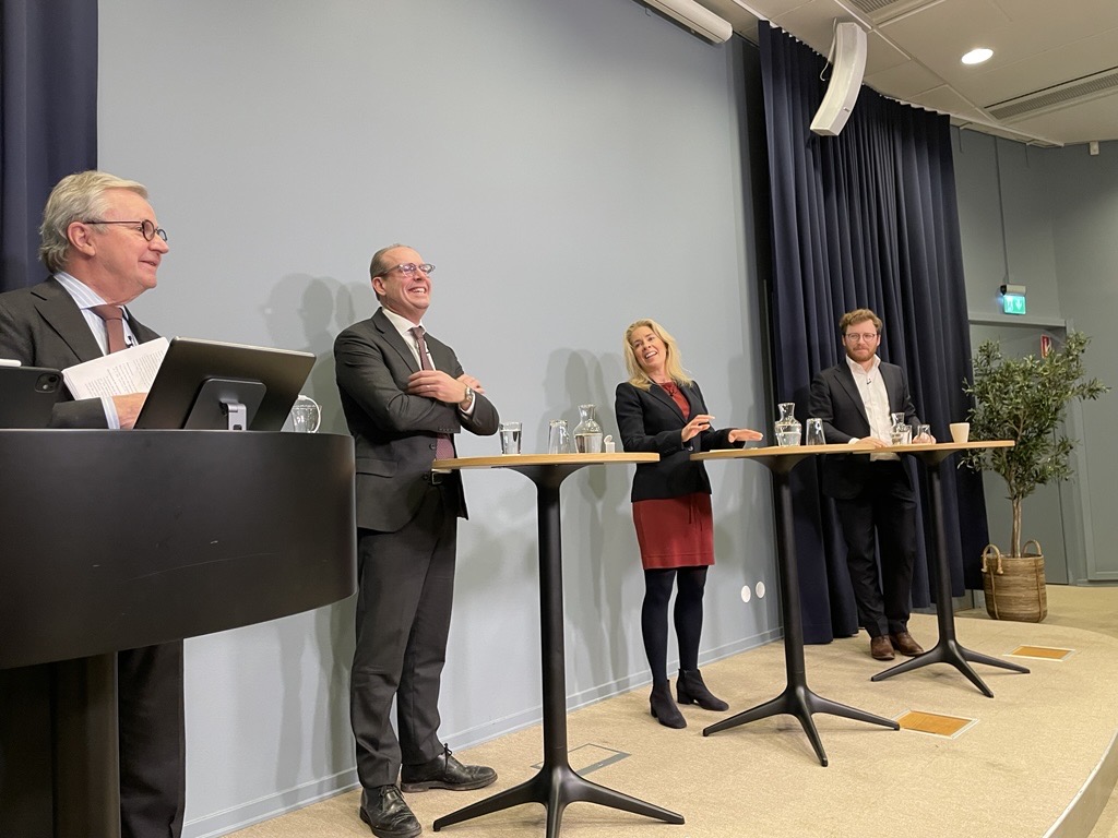 Four speakers presenting during a seminar on stablecoins and the digital euro