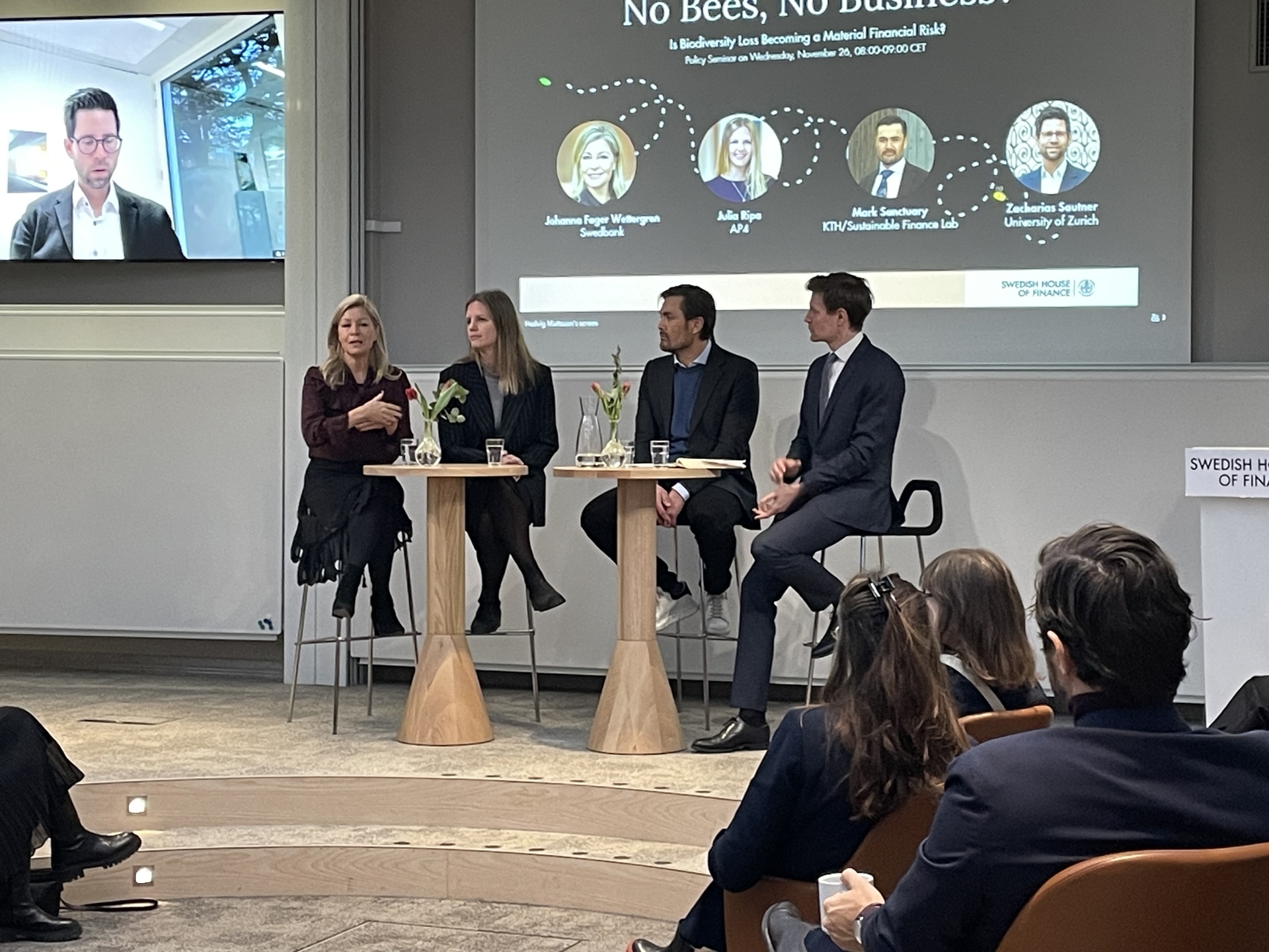 Four panelists speaking at the seminar
